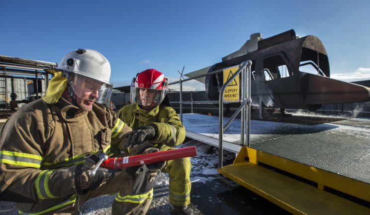 Firefighters examining hose