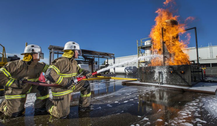 Group of trainees learning to safely put out fires on a ship at the ERGT facilities in Perth, Melbourne and Darwin.