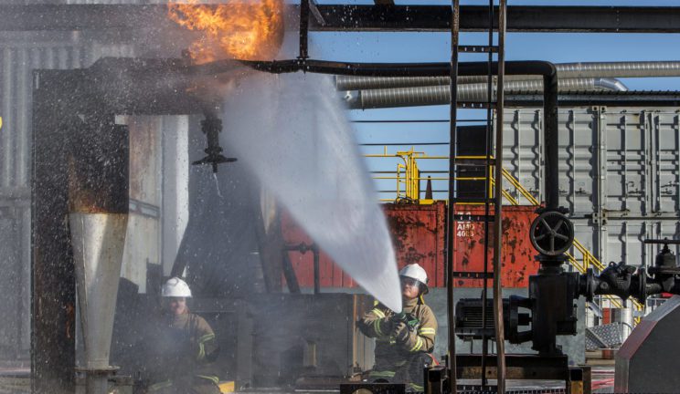 Students learning to safely deal with emergency fires whilst boarding ships
